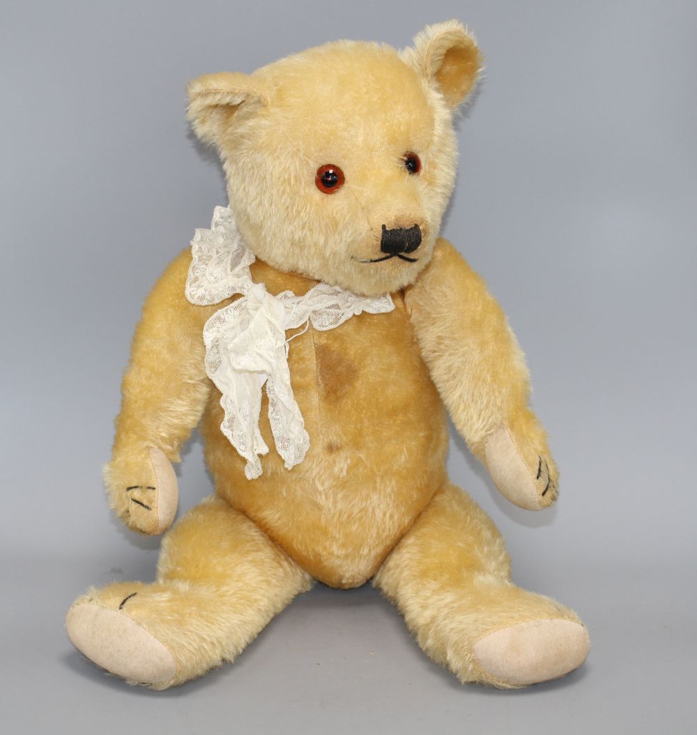 A Chiltern type bear, blond mohair, glass eyes, original pads, some slight staining on centre seam otherwise good condition